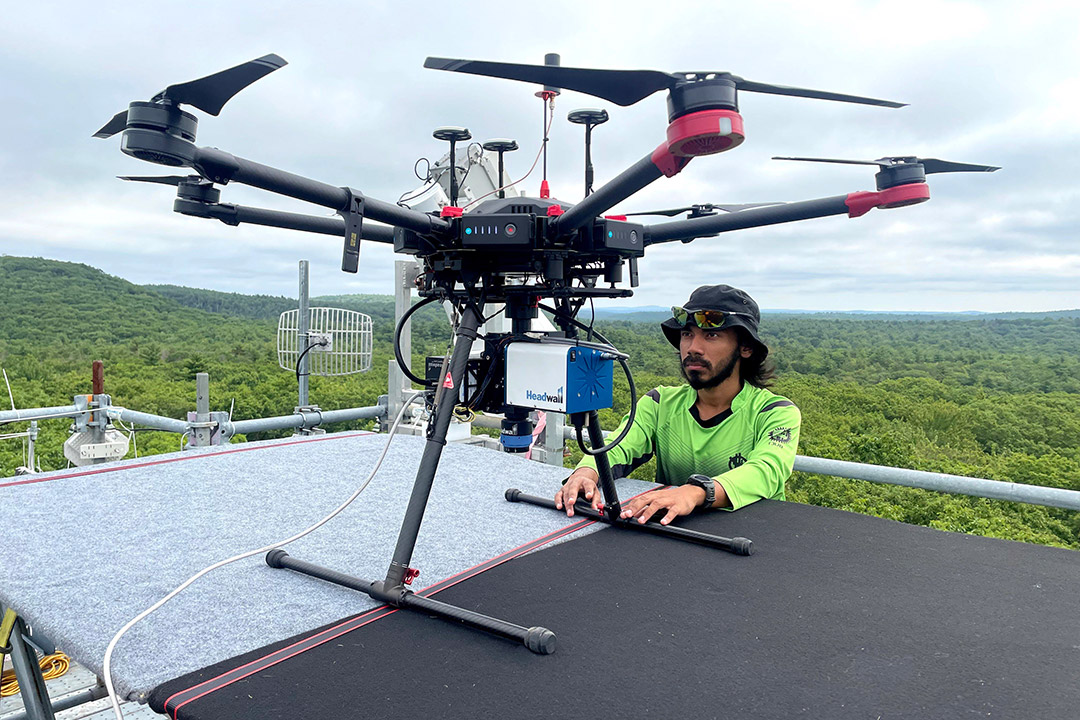 Imaging science Ph.D. student Mohammad Saif prepares a drone for data collection atop a 90-foot tower.