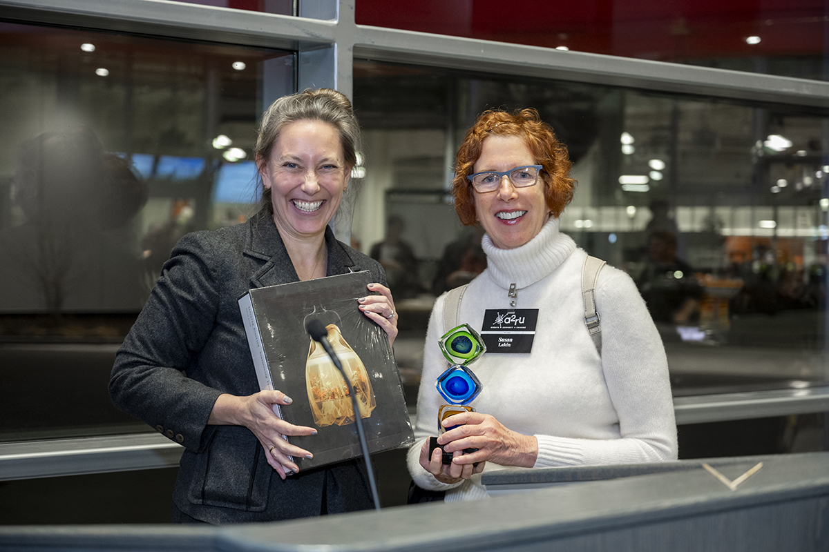 Susan Lakin and Maryrose Flanigan pose with an award Susan received.