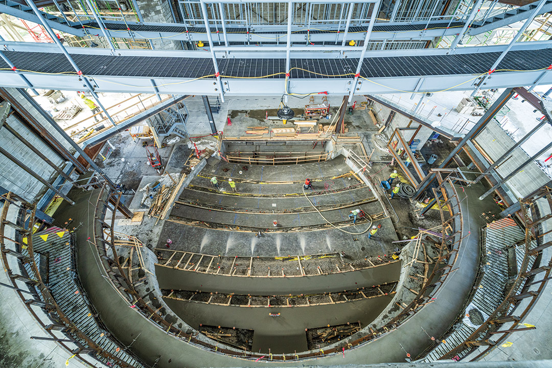 a 750-seat theater is shown being built.