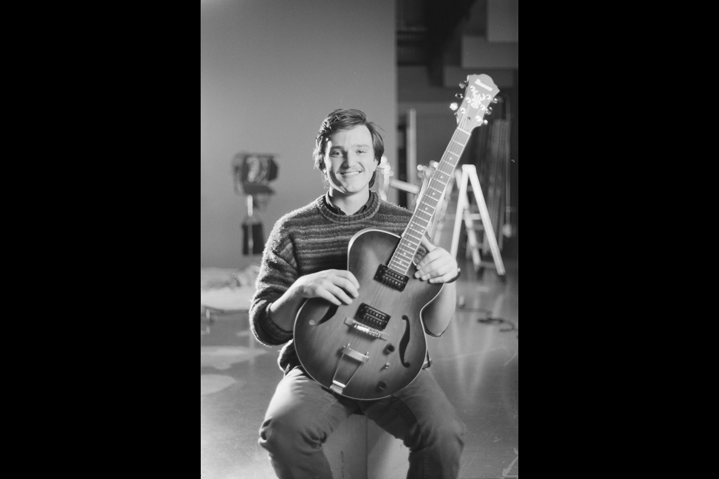 Colin O'Brien holding a guitar.
