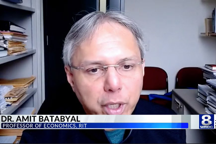 Amit Batabyal appears on screen with a chyron displaying his name and the W R O C logo.