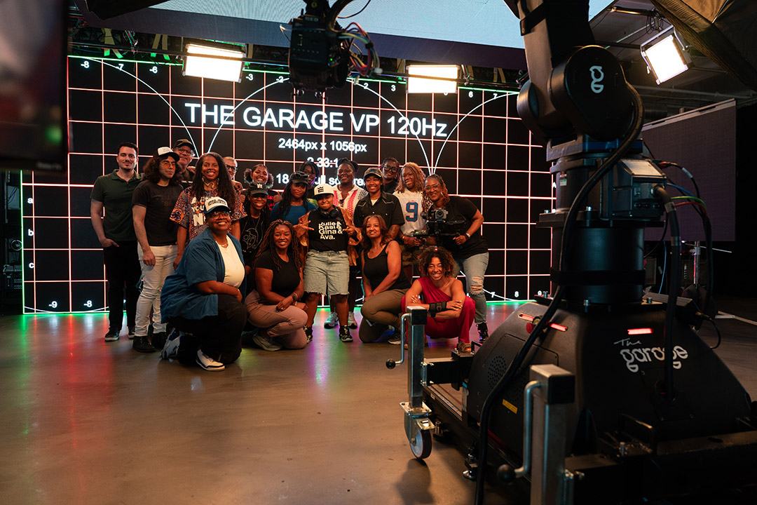 a group of young adults stands in a group in The Garage which is a film studio.