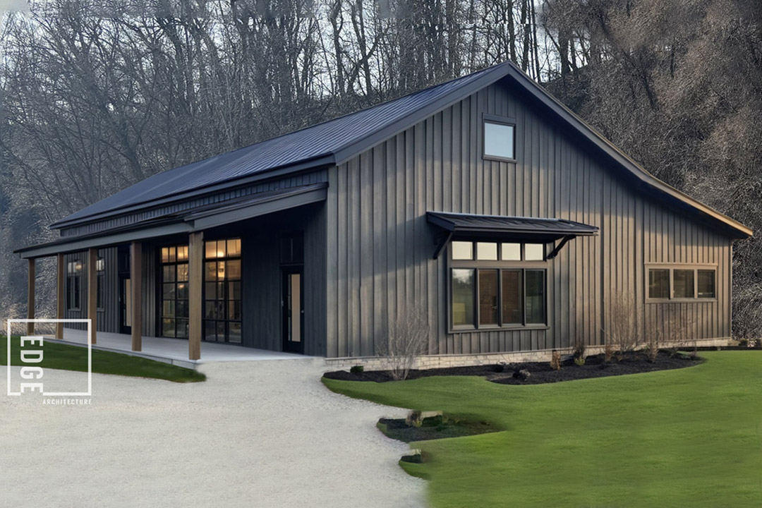 a modern brown cabin sits in a wooded area next to a gravel driveway.