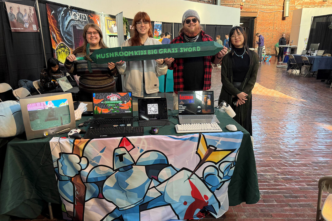 four people stand next to each other at a table themed for 'Mushroom kind's big grass sword'