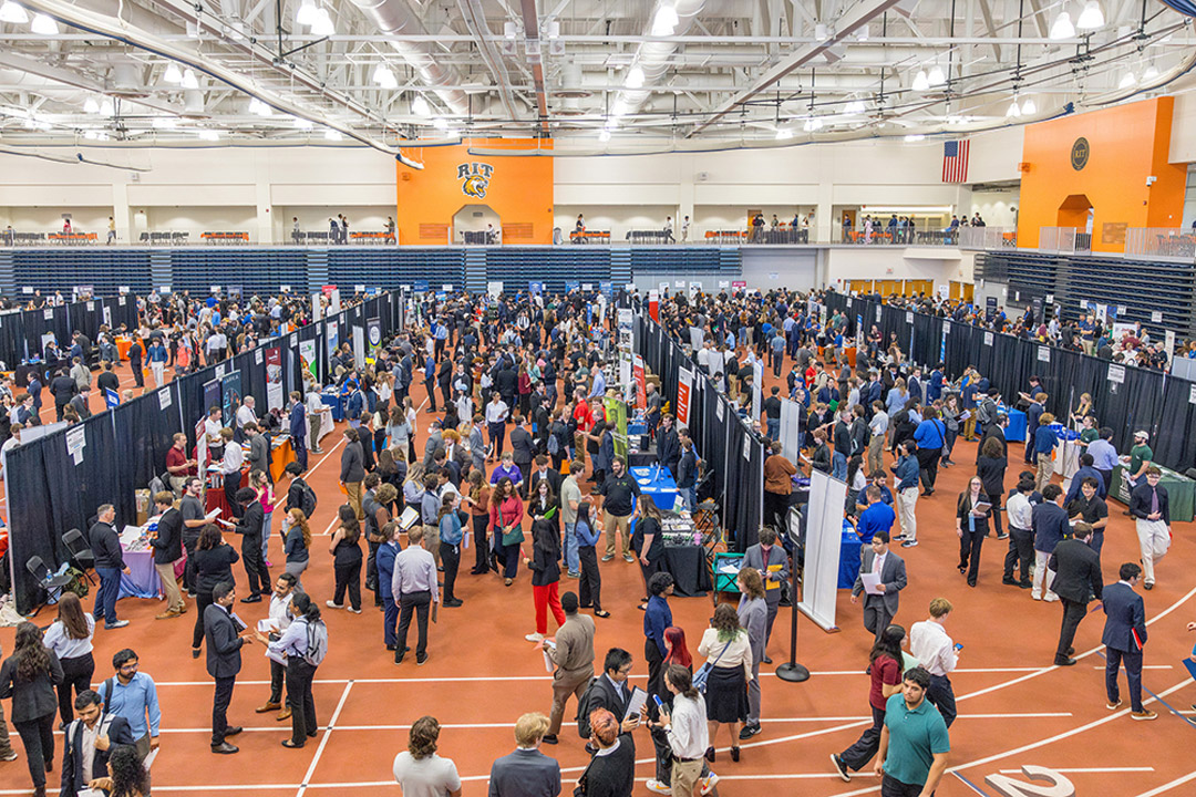 'a birds eye view of the R I T gymnasium full of people attending a career fair'