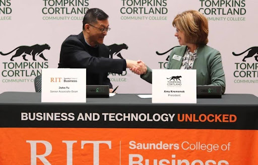 John Tu and Amy Kremenek shaking hands