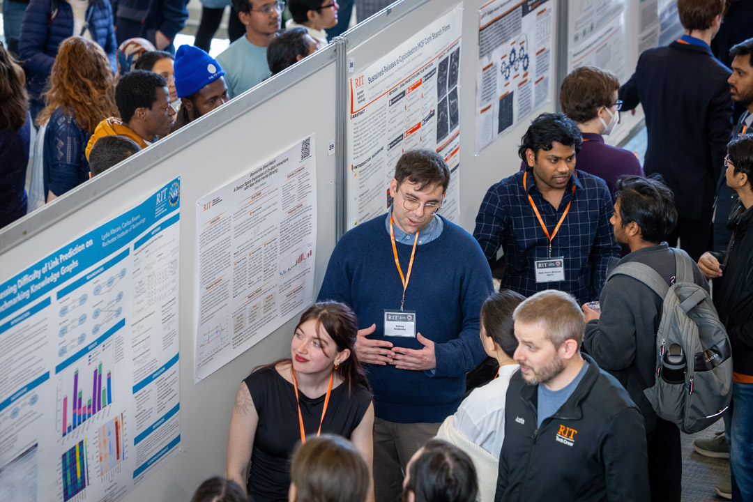 idney Grabosky, center, talks about how people might use smartwatches in the future at the RIT Graduate Showcase