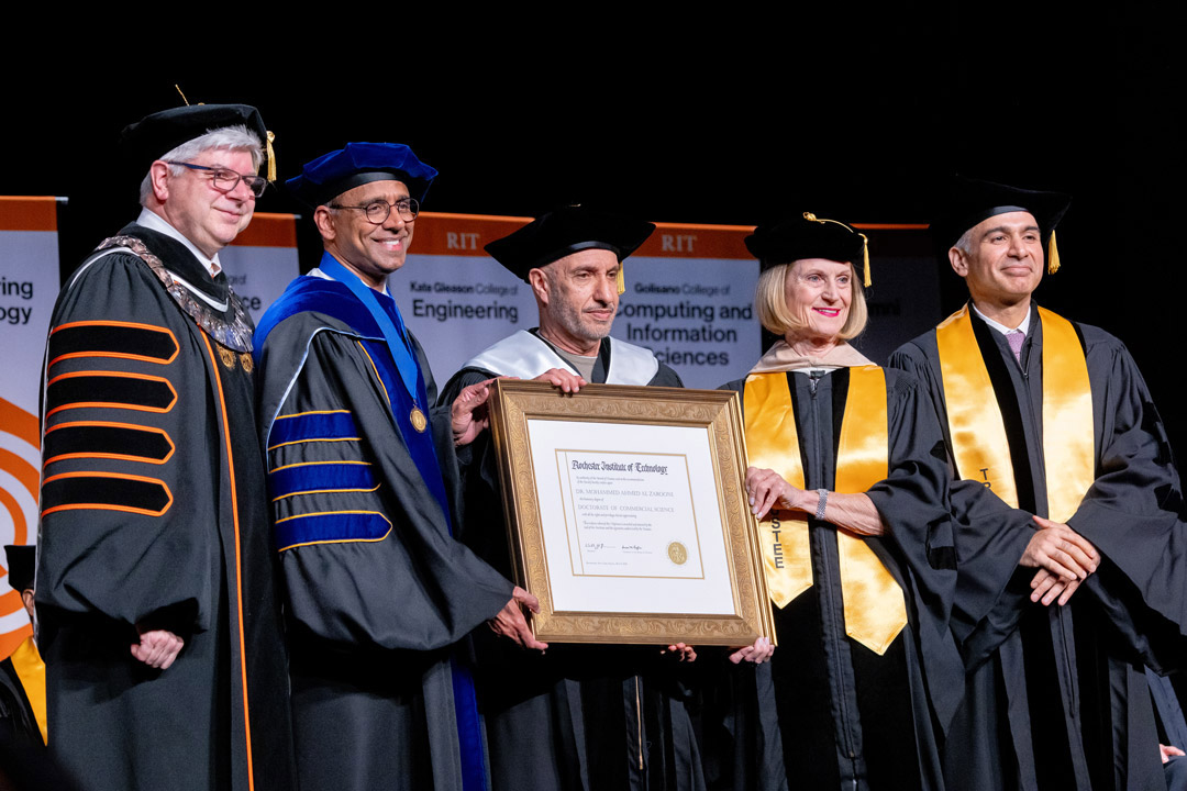 Mohammad Al Zarooni, center, was recognized during Academic Convocation on May 8, receiving an Honorary Doctor of Commercial Science degree. Joining him on stage, left to right, was RIT President Bill Sanders, RIT Provost Prabu David, RIT Trustee Vice Chair Susan Holliday, and RIT Trustee Darshan Hiranandani. 