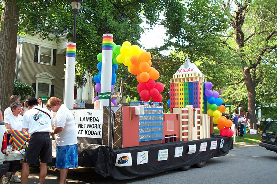 A colorful parade float featuring a mock Kodak building