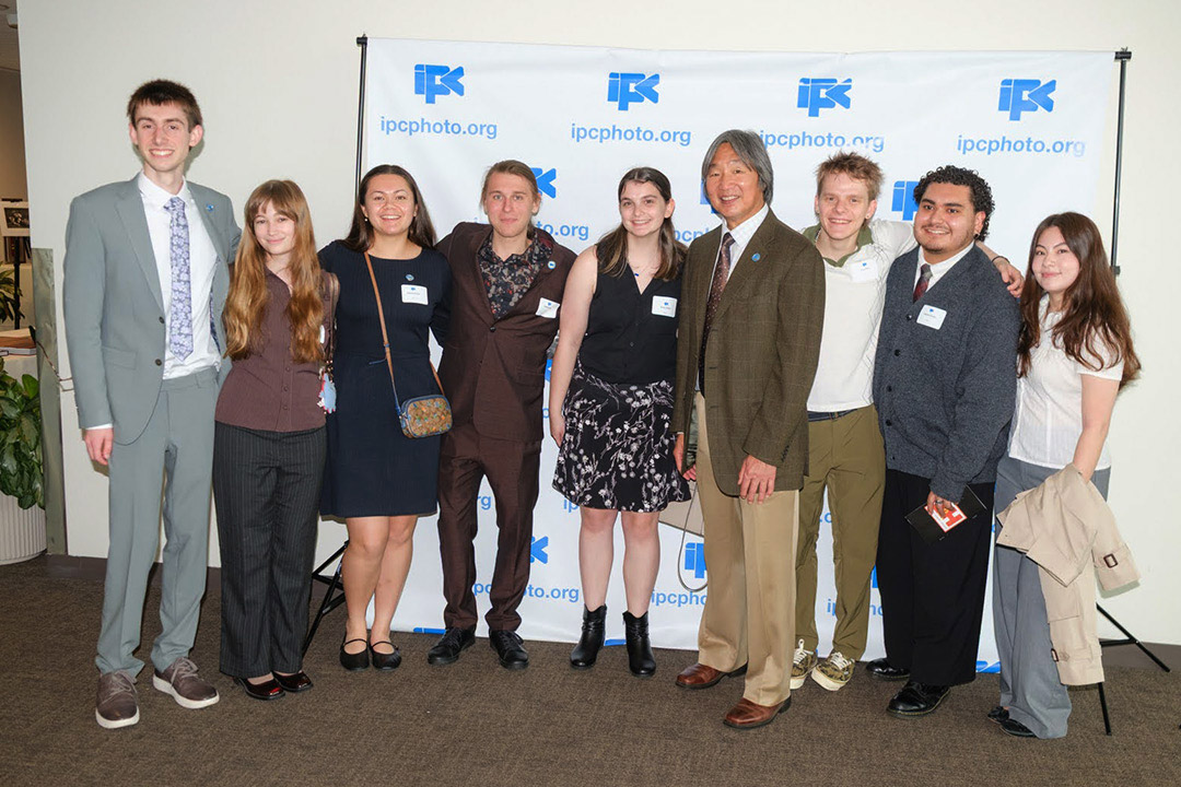 two men pose for a photo with students from the RIT in NYC program during the International Photographic Council’s luncheon at the United Nations