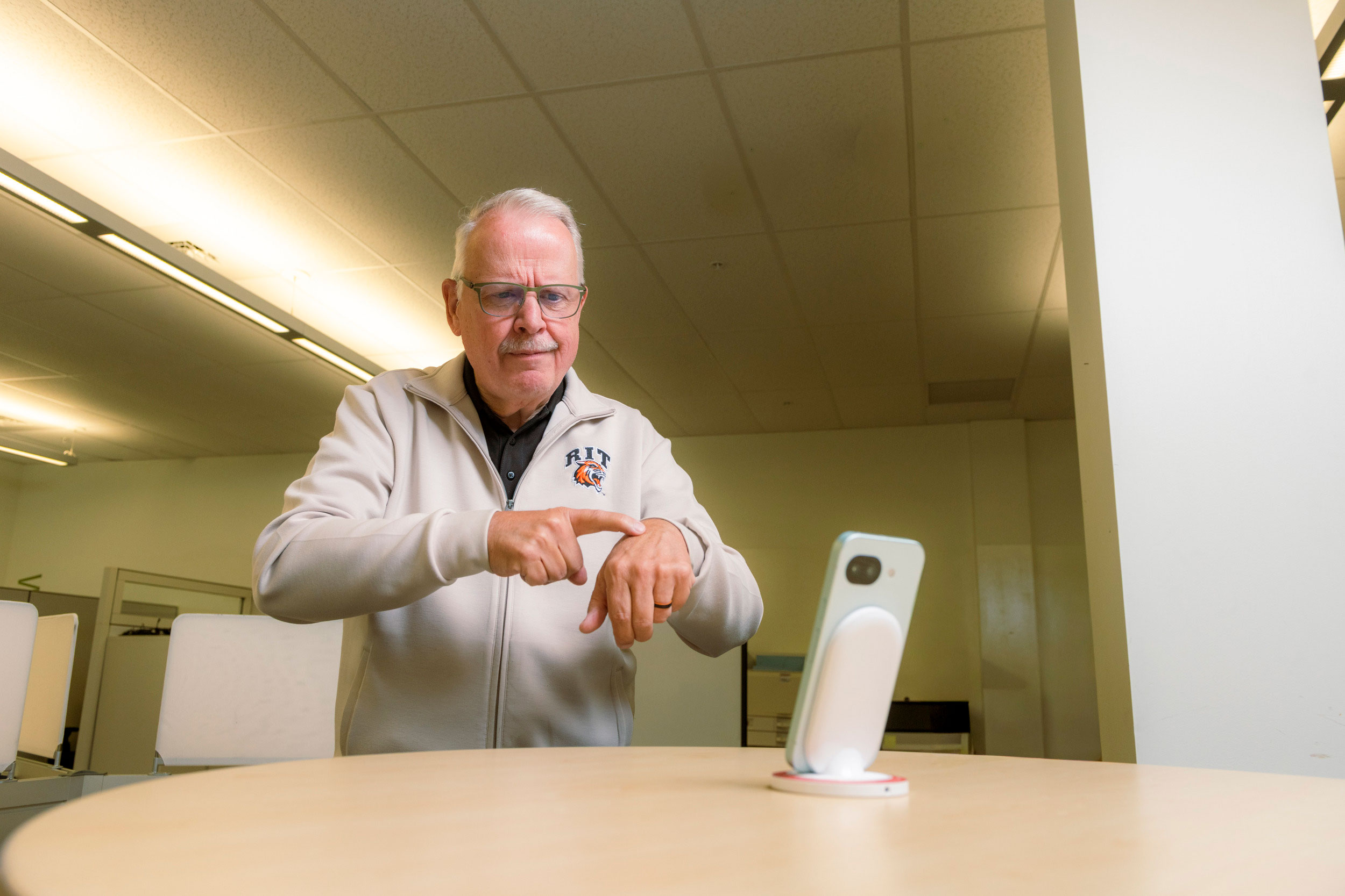 Gary Behm, director of the NTID Center on Access Technology, uses Google’s Sign Language-to-Text app, which he and others in the center helped evaluate prior to its release. 