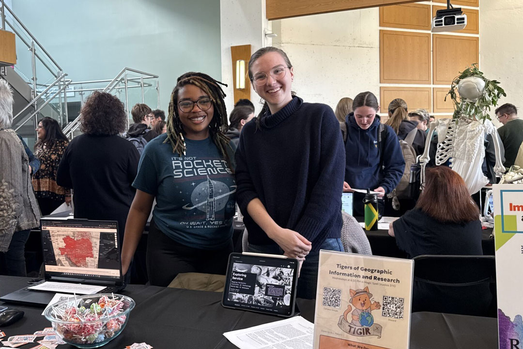 RIT students Destiny Patton, left, and Priscilla Anderson, right, spread the word about the Tigers of Geographic Information and Research (TIGIR) during a GIS immersion/minor fair. This new club looks to introduce students to the wide array of applications in the geospatial world. 