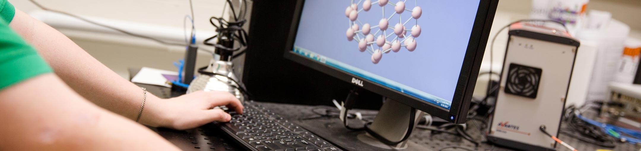 Close up of a person working on a computer.