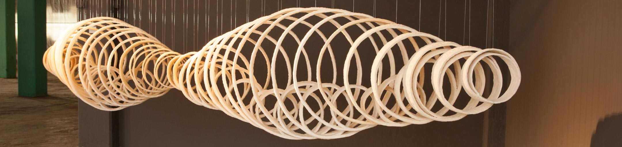 A hanging sculpture of concentric ceramic rings