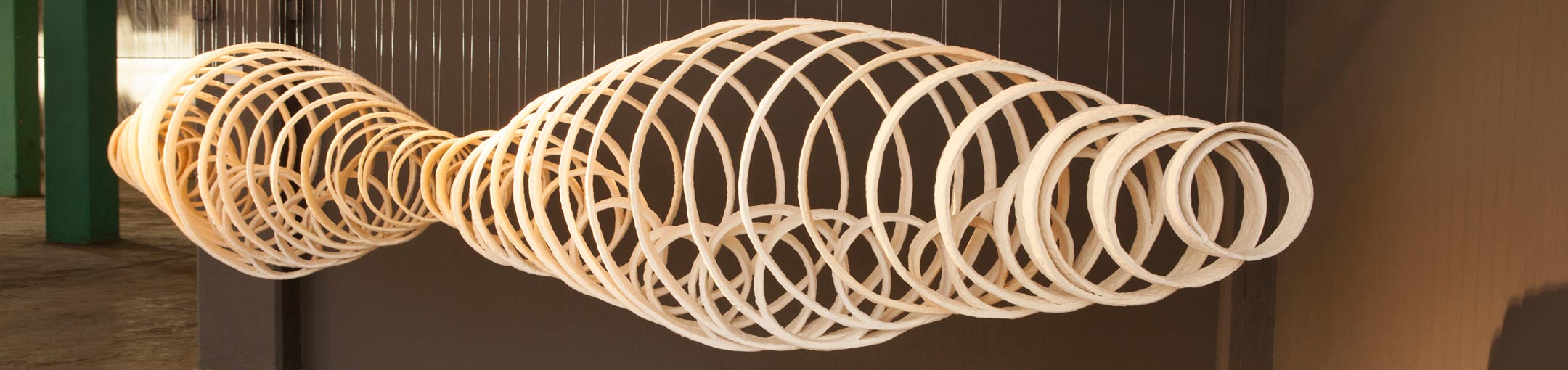 A hanging sculpture of concentric ceramic rings.