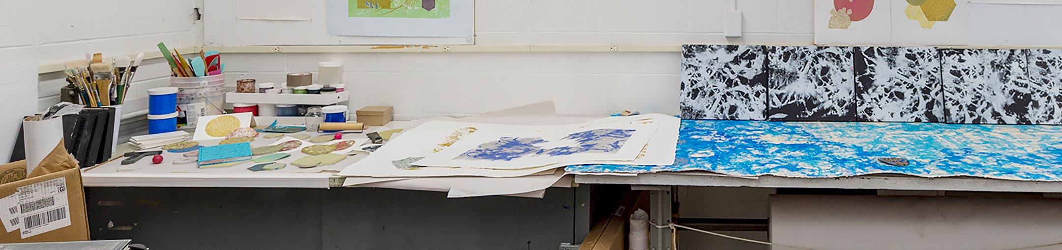 Texture artwork laying across studio tables.