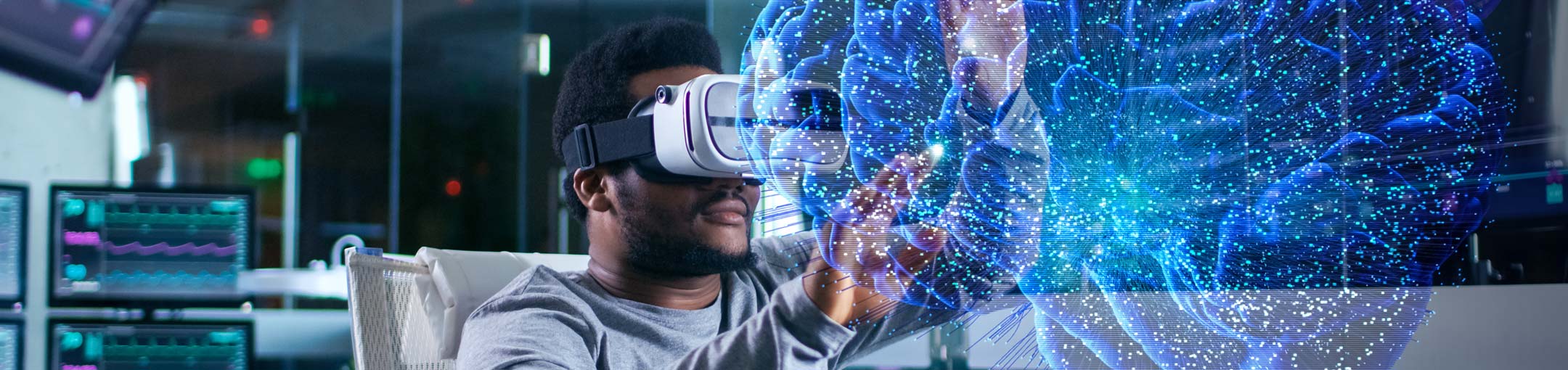 Student uses VR goggles and appears to be looking at a blue, 3D brain.