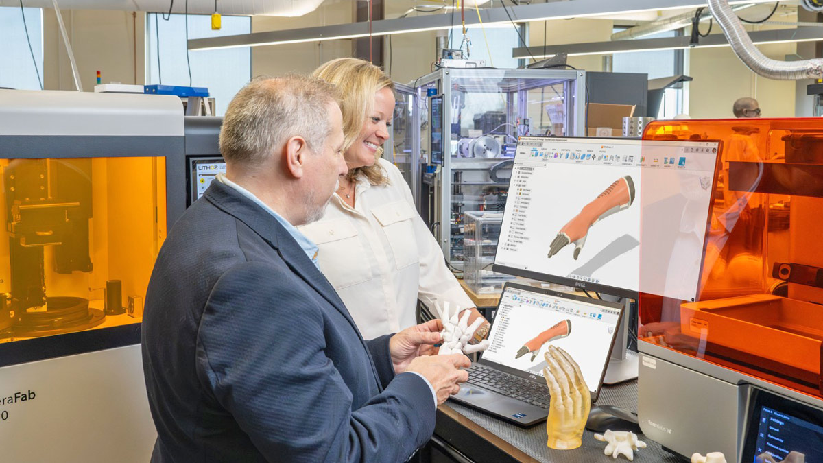 An occupational therapy faculty works in the AMPrint Lab.