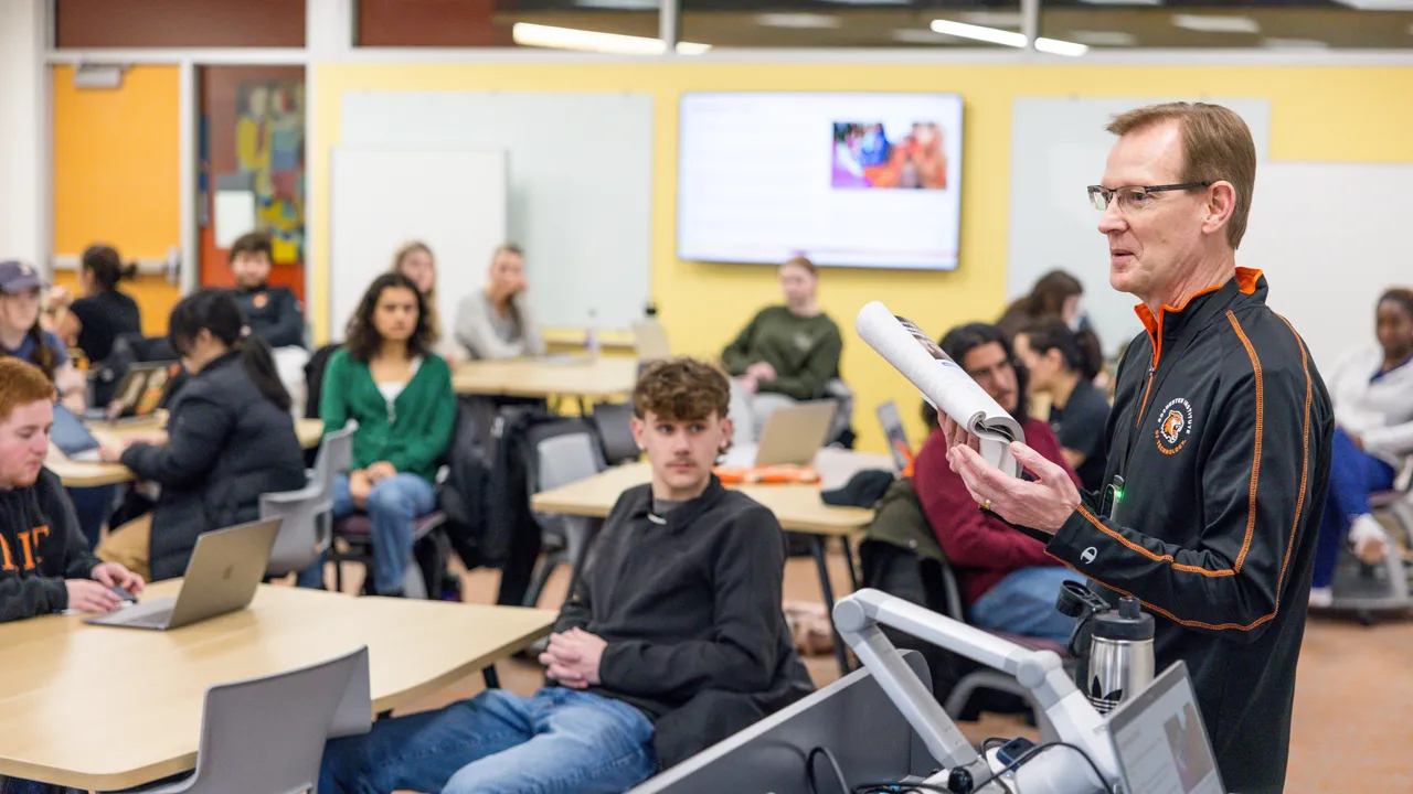 A professor talks to a room of students.