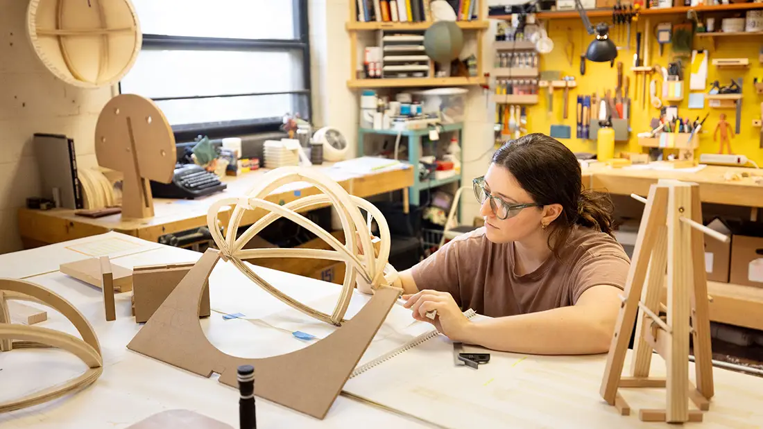 Woman wearing safety glasses working in a workshop