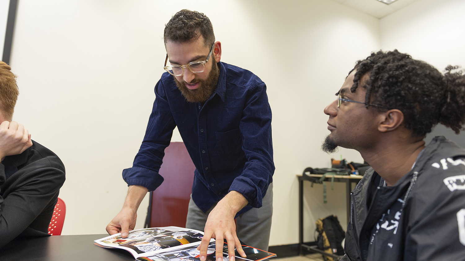 Aaron Gordon, founder of video production company Optic Sky, works with a student.