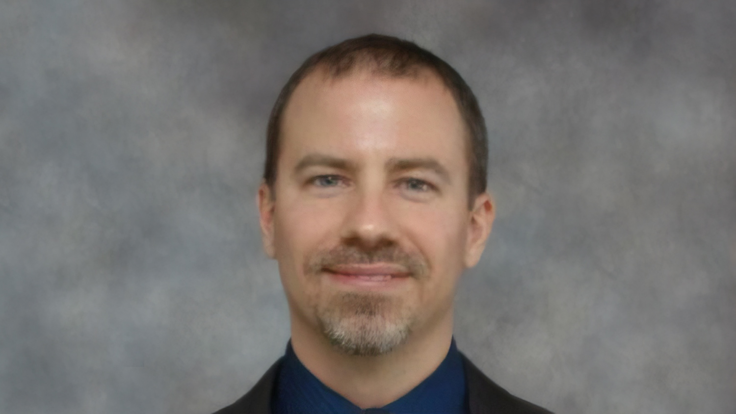 Portrait of Matthew Crump on gray background