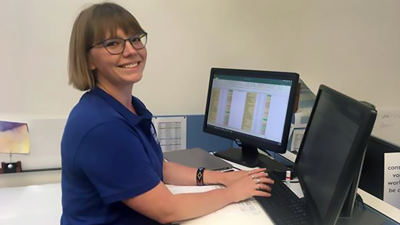 female graduate student working on a computer