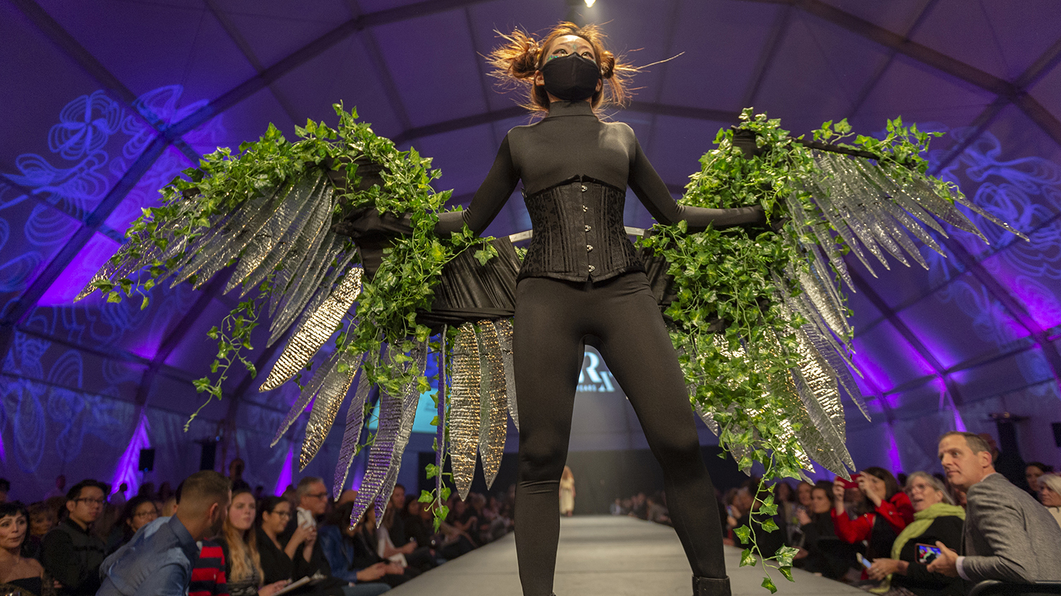 A fashion design featuring leaf-covered and sparkly wings.