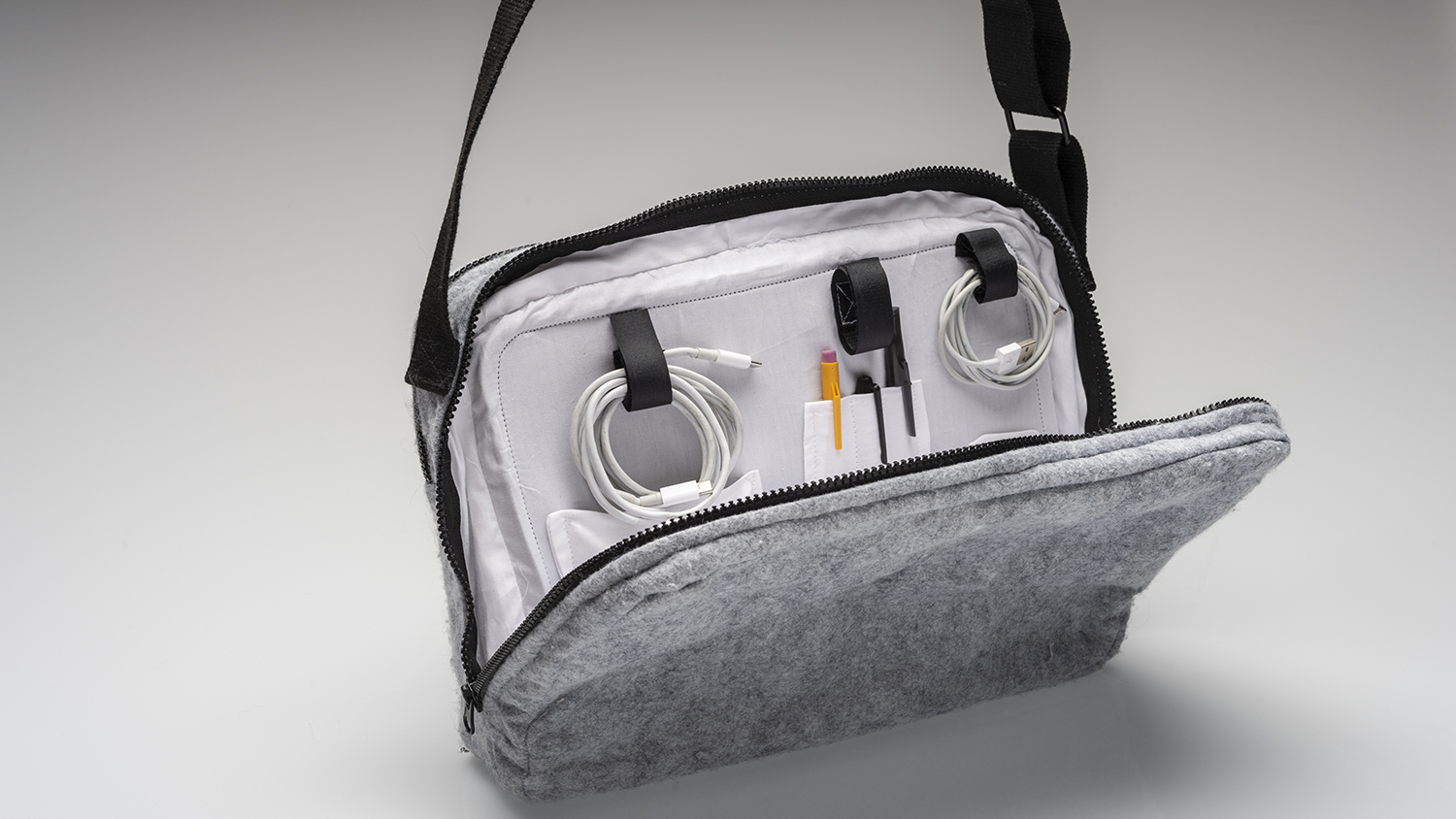 A bag with phone accessories and pens in it. 