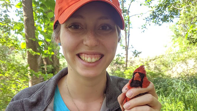 female student holding a bird