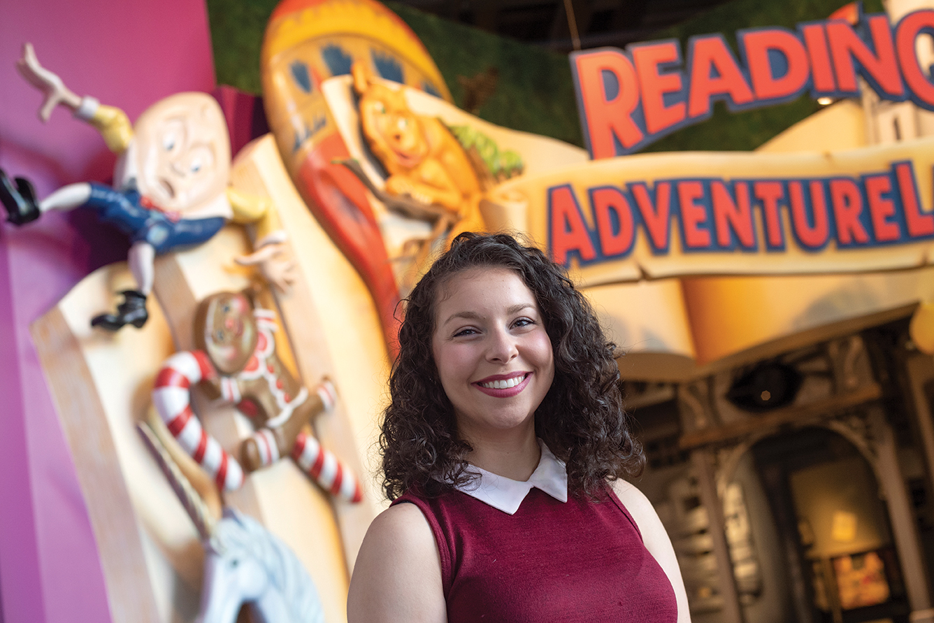 Museum studies student Vanesa Chiodo stands in front of the Reading Adventureland at The Strong National Museum of Play, where she completed a cooperative education experience.