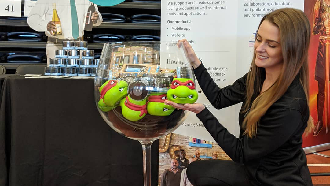 Britt Ali poses in front of a big wine glass at Total Wine and More's table at Creative Industry Day 2020.