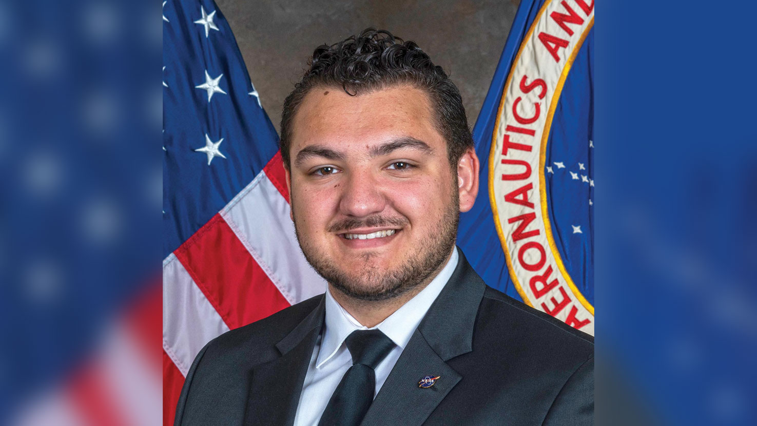 A portrait of Bailey Reid in front of US and NASA flags.