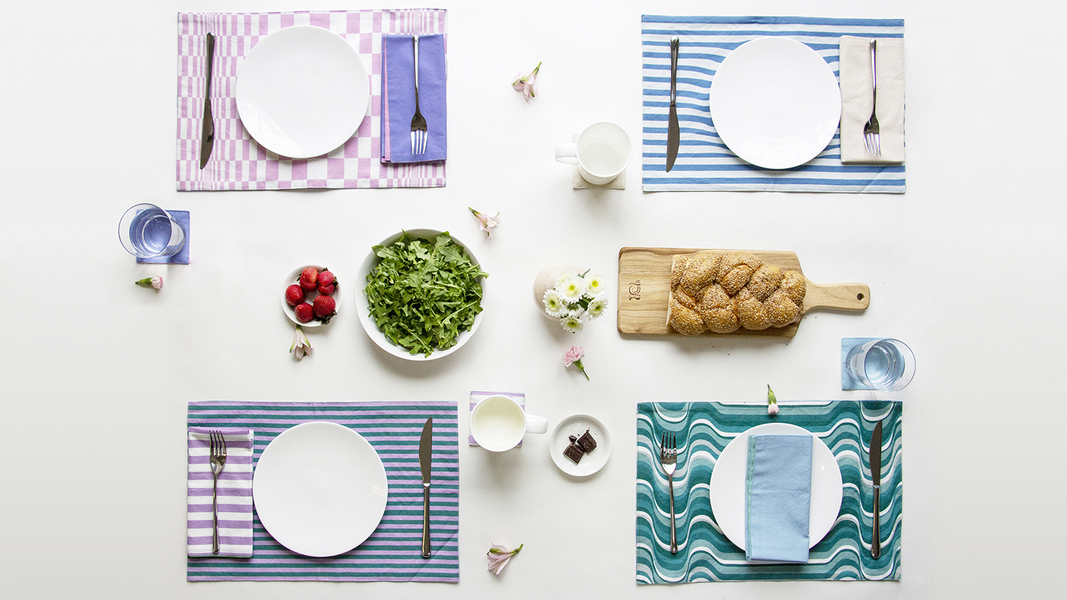 Placemats and food on a table.