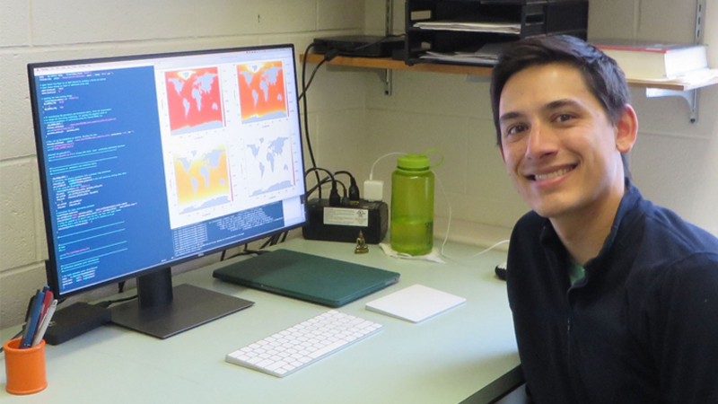 Dr. Tony Wong sitting at desk in front of computer