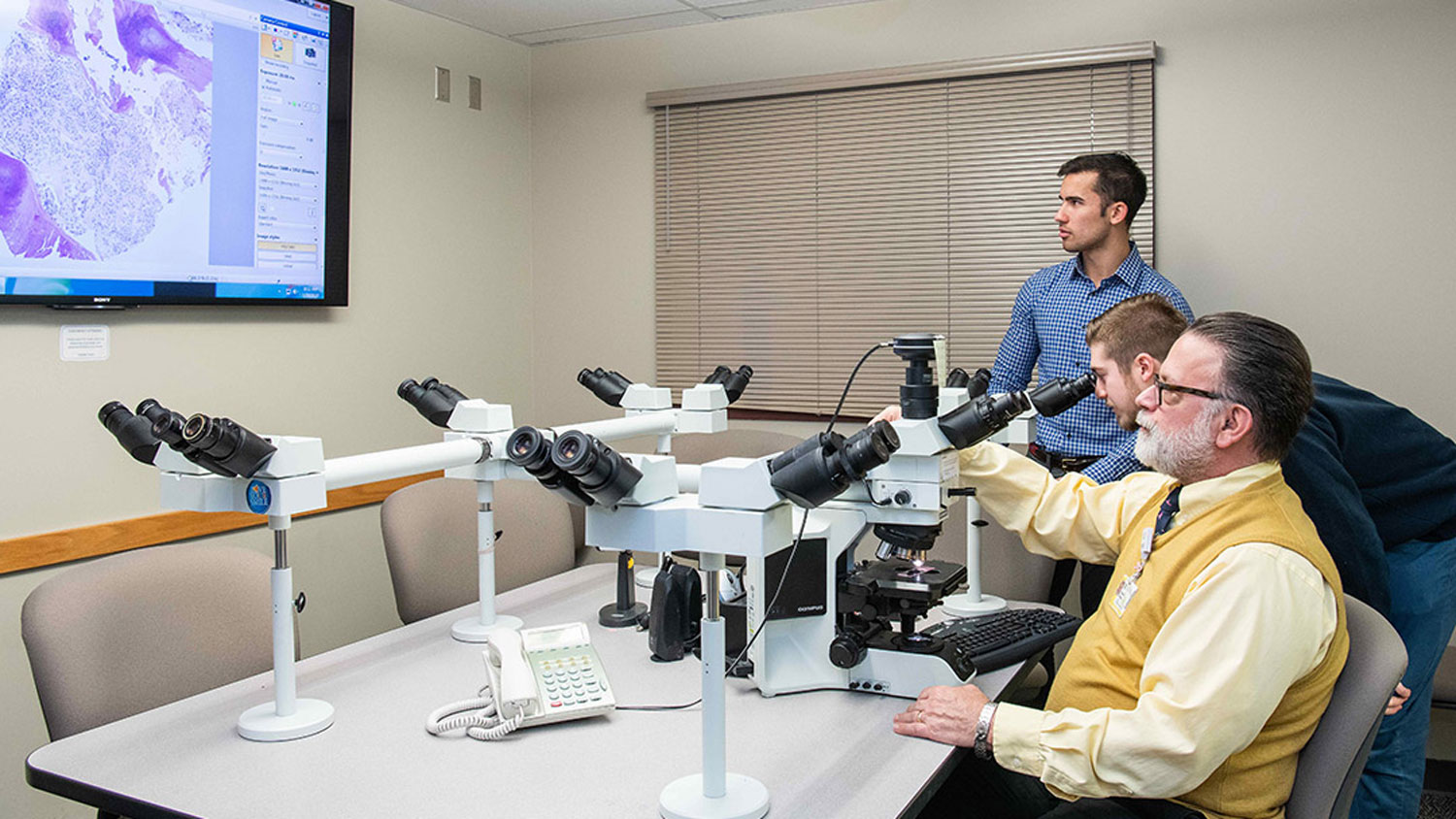 Biomedical engineering students Brandon Buscaglia and Marcus D’Aguiar work in a lab with Dr. David Hicks to develop a digital microscope.  