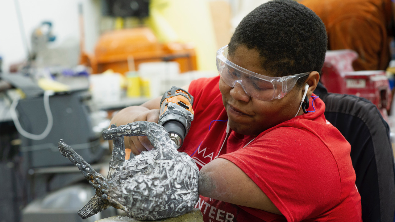 Shawanda Corbett works on a sculpture. 