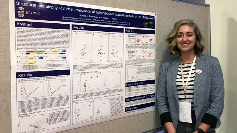 Kaylee Mathews presenting a poster at Brown University