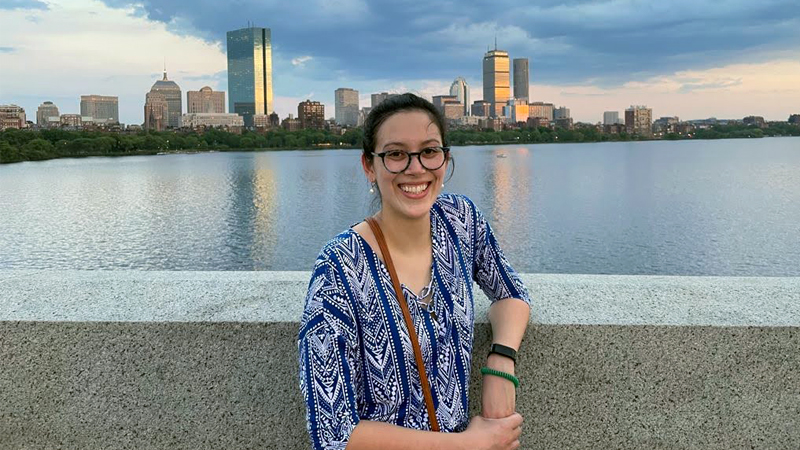 Selene Chew standing in front of the Massachusetts skyline