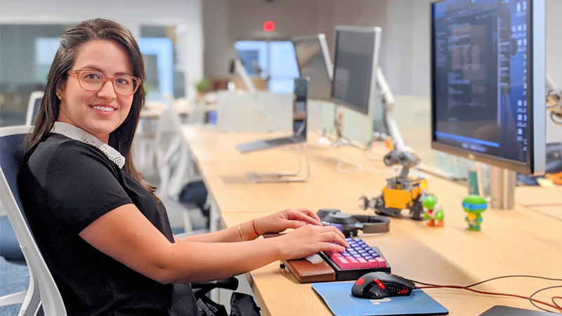 Melissa Royo sitting in front of a computer