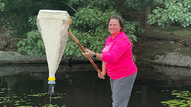 Sandi Connelly collecting invertebrates in a pond