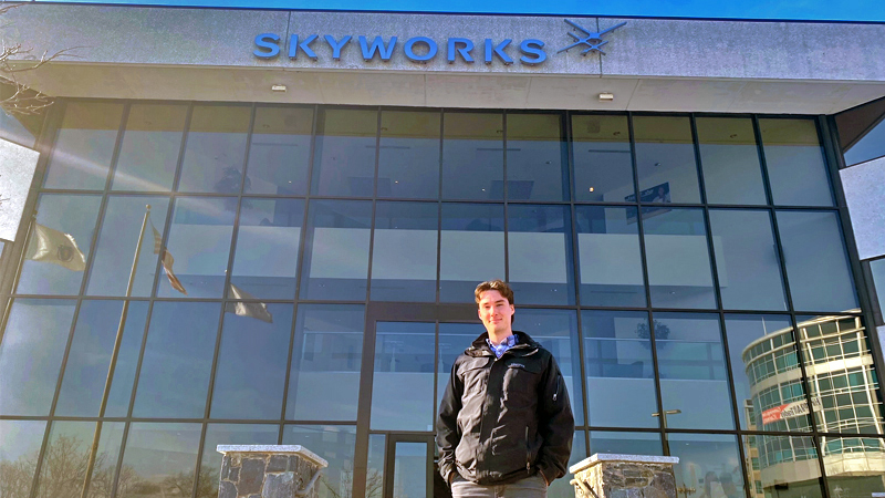 Alex Knowles standing in front of Skyworks building