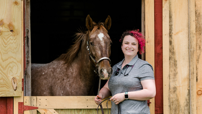 Liliya Becktell standing next to a horse