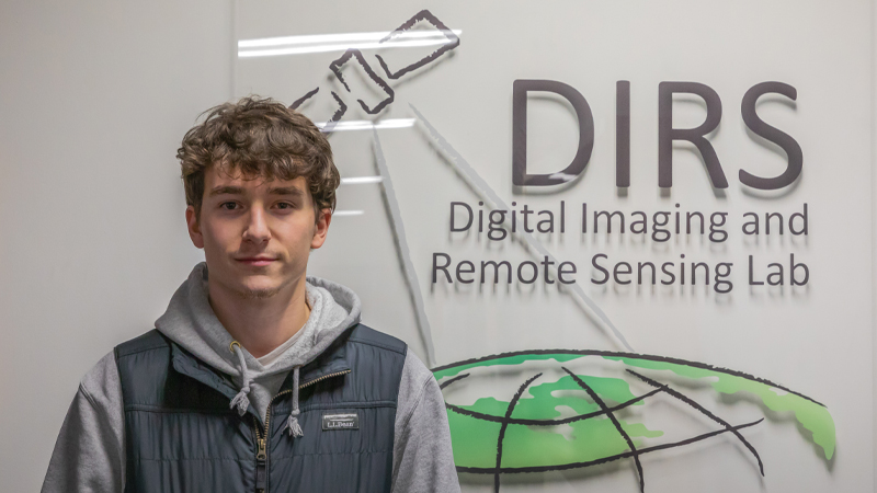 Gabriel Peters standing in front of the DIRS Lab at RIT