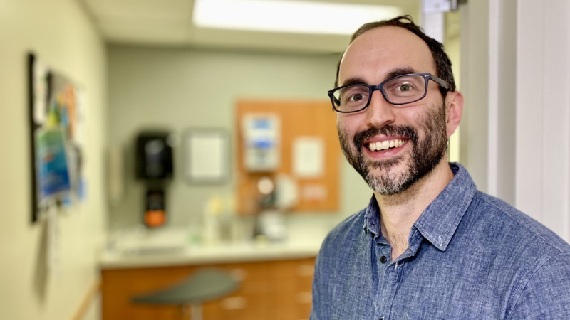 a photo of Anthony Jiminez near a health care screening room 