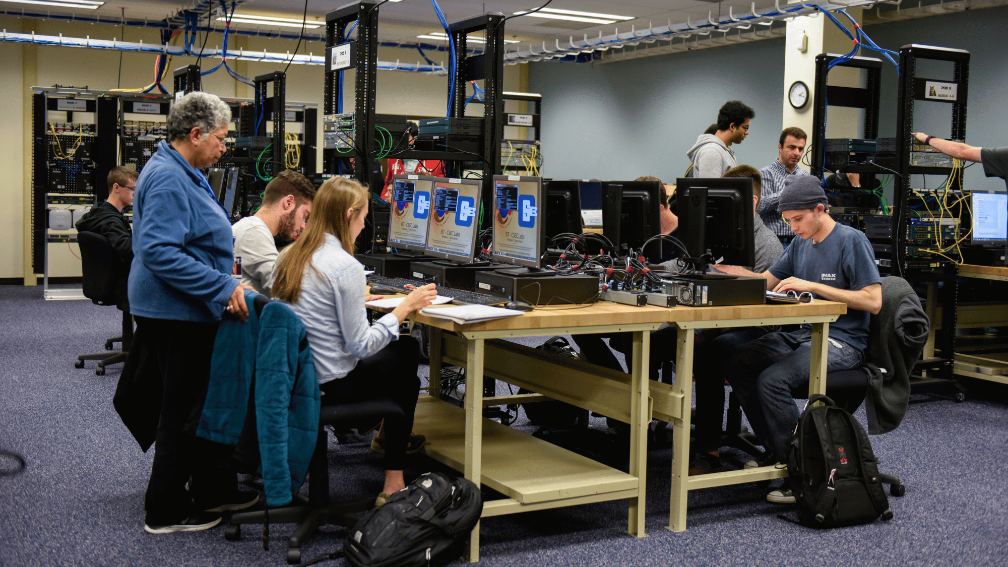 Professor instructing students during a lab