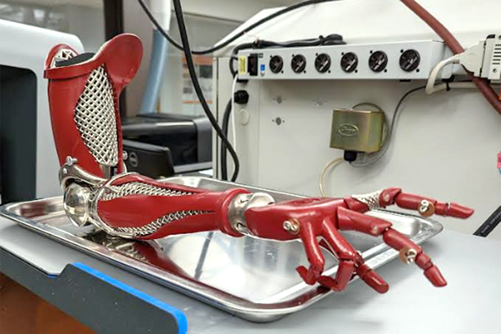 A red robotic arm bent at the elbow