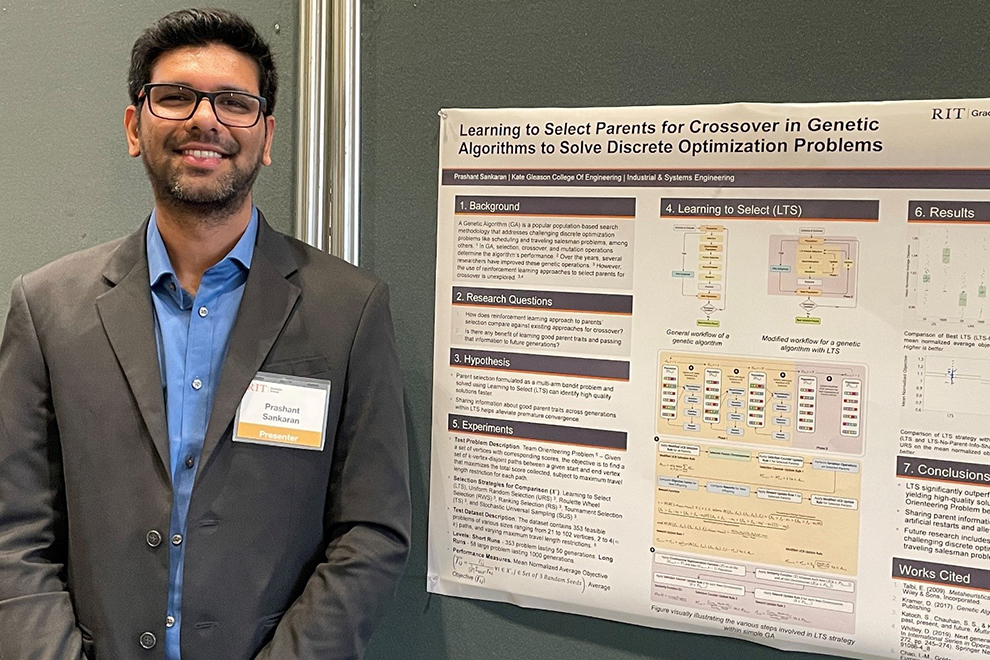 A Ph.D. student standing next to a research poster on the wall.