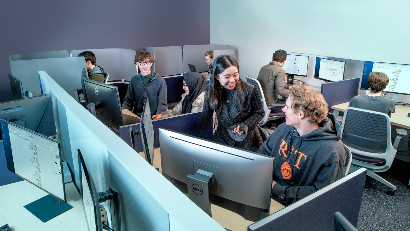 Jiangnan Xu (stood, center) oversees a group of students working within the Niantic x RIT Geo Games and Media Lab
