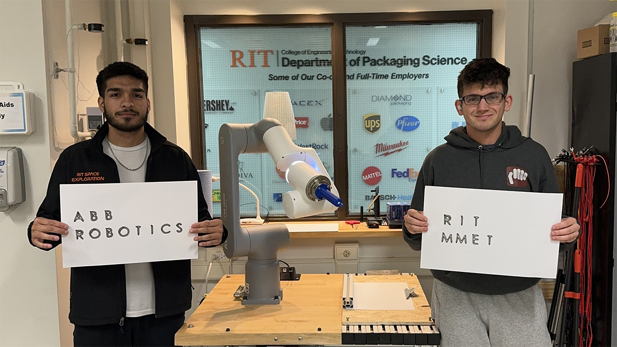 Mechanical and Manufacturing Engineering Technology, MMET, student team at RIT with ABB robot, showing off ASL American Sign Language robotics project